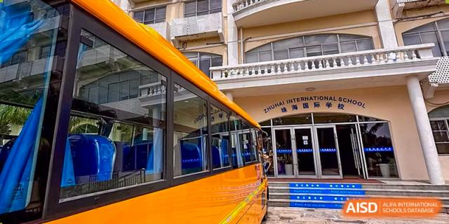The large, bright yellow bus used for transport and field trips at Zhuhai Qiao International School.