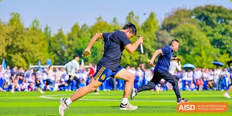 Close-up of a student or athlete from Chengdu No.7 High School International Department sprinting on the green field during a track event.