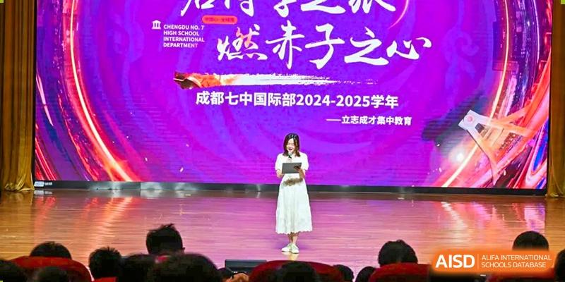 Chengdu No.7 High School International Department student performing or giving a speech on stage in a white dress with purple lighting.