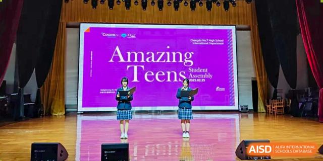 Chengdu No.7 High School International Department students standing on stage at the "Amazing Teens Student Assembly" event, with the school's name displayed on the banner.
