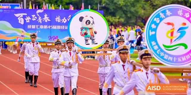 Chengdu No.7 High School International Department students in uniform marching, with a picture of a panda mascot displayed in a circle frame.