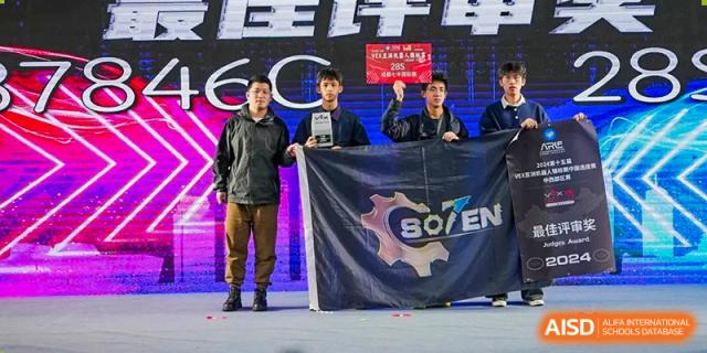 Chengdu No.7 High School International Department students holding a dark blue banner with a gear logo for a club or event.