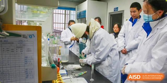 Chengdu Shishi High School Cambridge A-Level Centre students perform a chemical experiment in a lab.