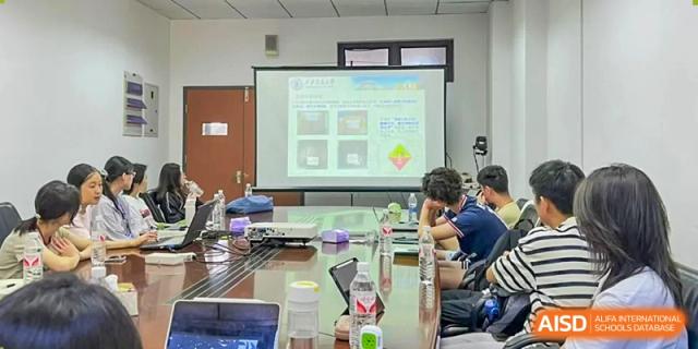 Chengdu Shishi High School Cambridge A-Level Centre students sit around a conference table looking at a screen.