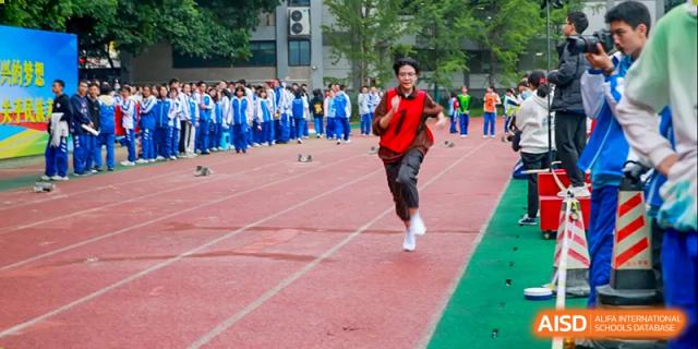 Chengdu Shishi High School Cambridge A-Level Centre students participating in a running event on a track.