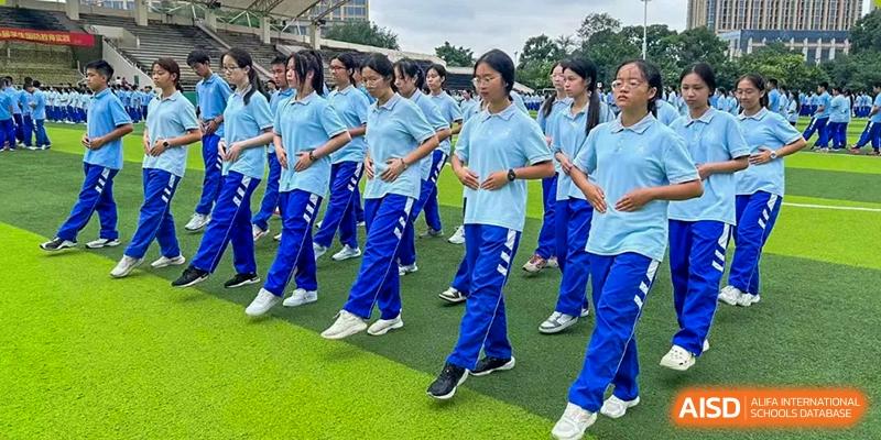 Chengdu Shishi High School Cambridge A-Level Centre students marching in formation while playing wind instruments.