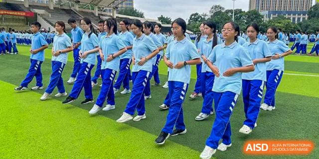 Chengdu Shishi High School Cambridge A-Level Centre students marching in formation while playing wind instruments.