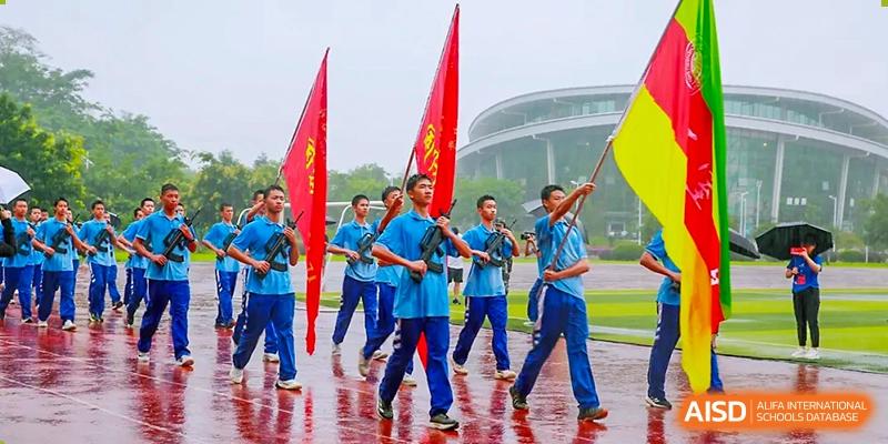 Chengdu Shishi High School Cambridge A-Level Centre students marching with flags and drumsticks.