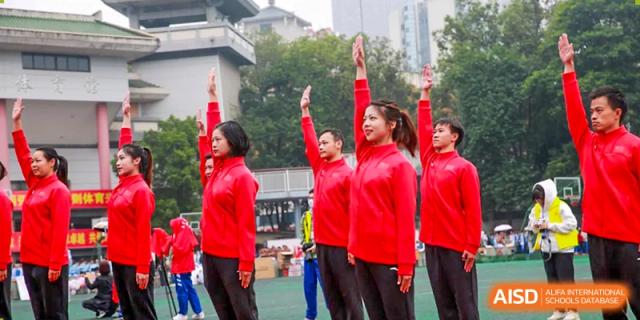 Chengdu Shishi High School Cambridge A-Level Centre teachers and staff in red jackets cheering.