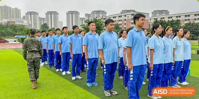 Chengdu Shishi High School Cambridge A-Level Centre students stand in formation on a grassy field.
