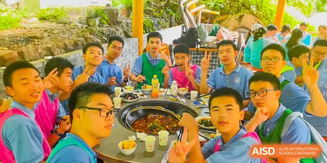 Chengdu Shishi High School Cambridge A-Level Centre students smiling while eating a meal.