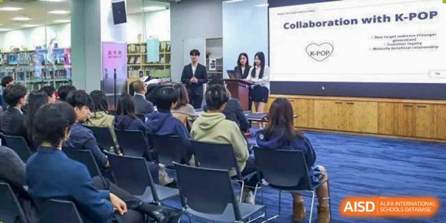 Concordia International School Shanghai students giving a presentation at the front of a classroom to their seated peers.
