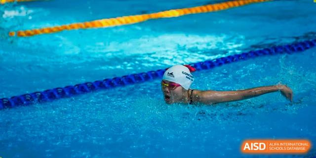 A close-up shot of a competitive swimmer from Concordia International School Shanghai taking a breath during a swimming race.