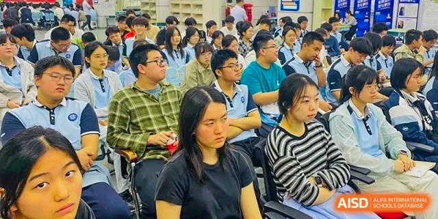 A close-up of a large group of students attentively listening during a presentation or class session at the Hefei No.1 High School.