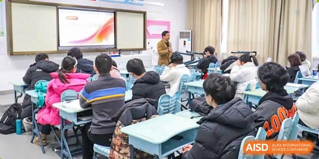 A teacher walking among the students during a classroom presentation or meeting at the  Hefei No.1 High School.