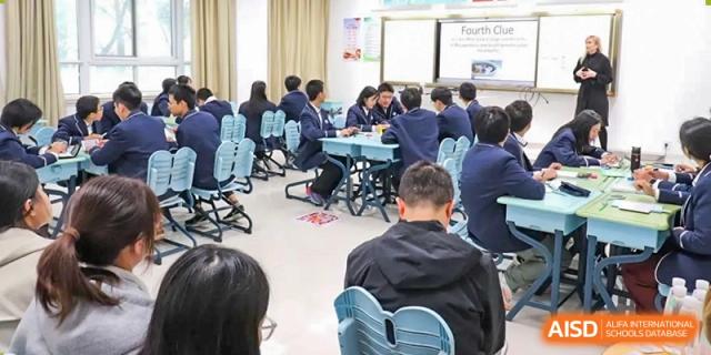 A full classroom of students seated in small groups, participating in a group discussion or collaborative learning activity at the  Hefei No.1 High School.