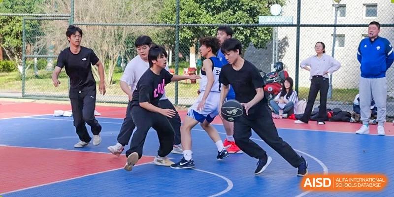 Students playing basketball during a friendly game on a blue and red outdoor court at the  Hefei No.1 High School.