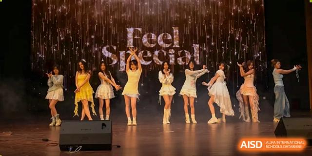 Dancers on a stage with a "Feel Special" banner, performing at a school event at the  Hefei No.1 High School.