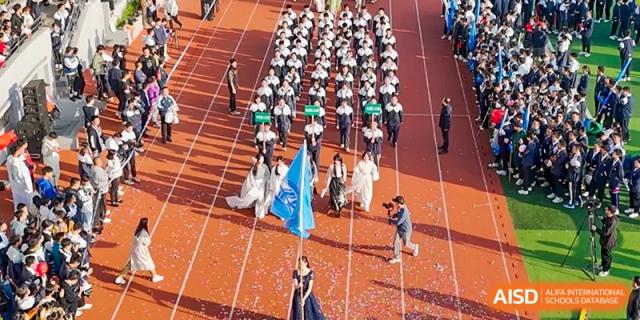 An aerial view of students marching in formation on the running track during a large school assembly or sports event at the Hefei No.1 High School.