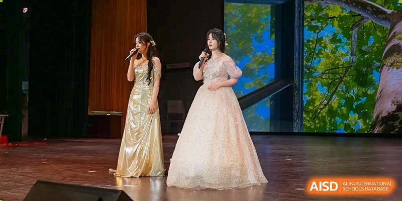 A student singing on stage in a formal gold dress during a school concert or gala event at the Hefei No.1 High School.