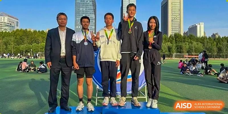 A group of students and teachers standing on a podium with medals, celebrating athletic or academic achievements at the Hefei No.1 High School.