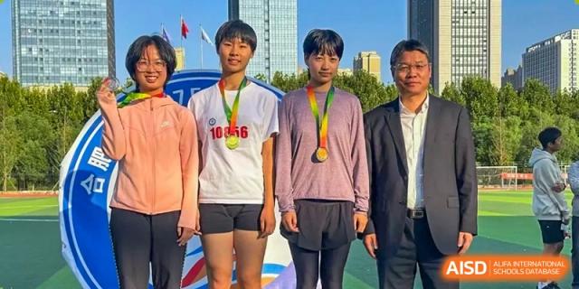 Students with medals standing proudly with teachers or administrators, celebrating achievement at the Hefei No.1 High School.