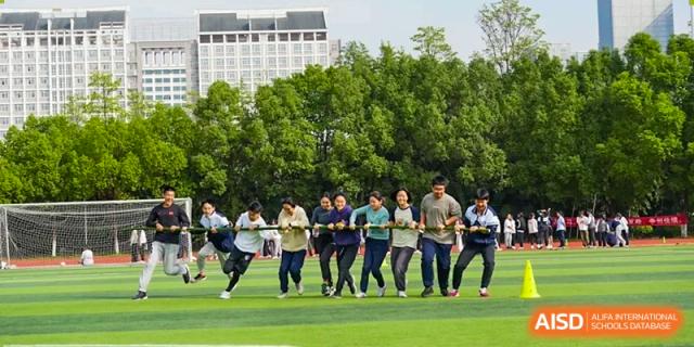 A group of students running together in a line during outdoor fitness or sports training at the Hefei No.1 High School.