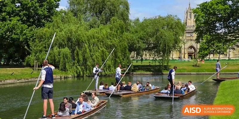 Students on a field trip or excursion, being guided on punting boats along a river at Huitong School & Studios.