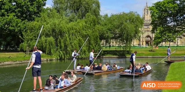 Students on a field trip or excursion, being guided on punting boats along a river at Huitong School & Studios.