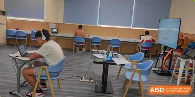 Interior view of a quiet classroom setting at QSI International School of Zhuhai with small tables and chairs.
