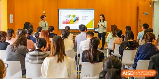 An image showing students sitting in an audience listening to a presentation at Wellington College International Shanghai.