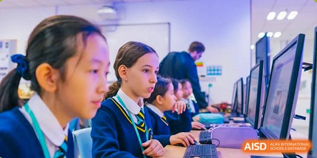 An image showing a student working on a computer in a classroom at Wellington College International Shanghai.