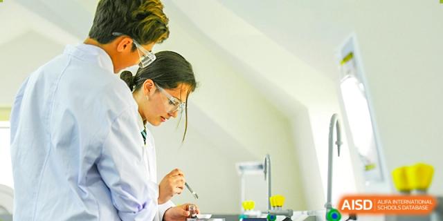 An image showing two students conducting a science experiment in a laboratory at Wellington College International Shanghai.