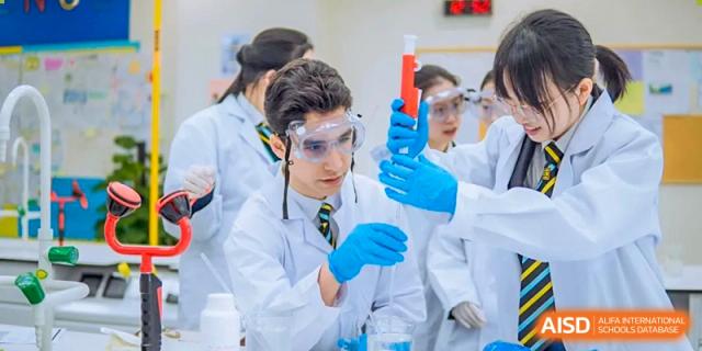 An image showing a student in a laboratory holding a test tube and a beaker at Wellington College International Shanghai.