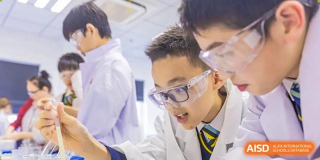 An image showing a student in safety goggles in a science laboratory at Wellington College International Shanghai.