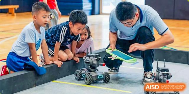 An image showing students looking at a remote-controlled car in a gymnasium at Wellington College International Shanghai.