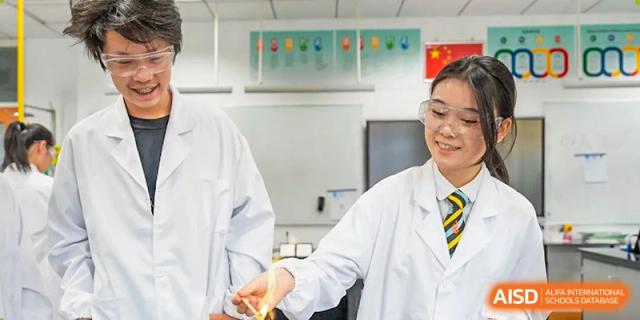 An image showing two students and a teacher in lab coats at Wellington College International Shanghai.
