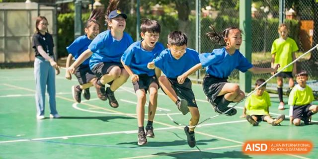 An image showing students jumping together during a sporting event at Wellington College International Shanghai.