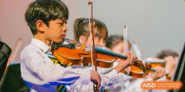 An image showing a boy playing the violin at Wellington College International Shanghai.