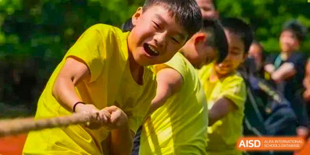 An image showing a student smiling at a sporting event at Wellington College International Shanghai.