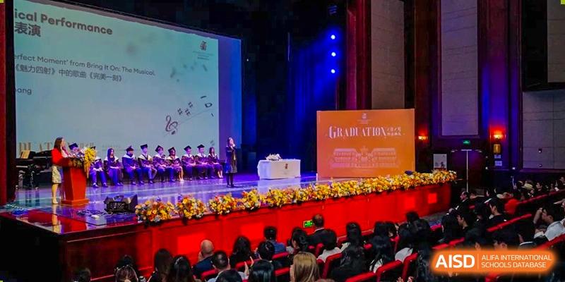 An image showing students performing on a stage during a graduation ceremony at Wellington College International Shanghai.