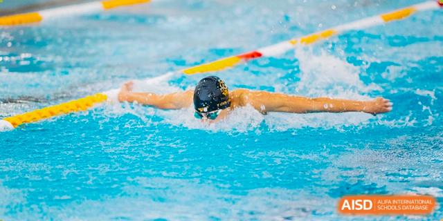 An image showing a swimmer in a pool wearing a cap and goggles at Wellington College International Shanghai.