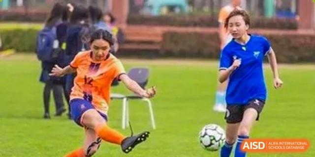 An image showing a close-up of a person kicking a soccer ball at Wellington College International Shanghai.