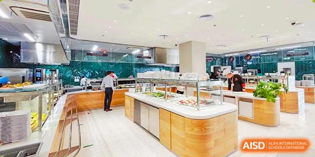 An image showing the interior of a cafeteria with a food buffet at Wellington College International Shanghai.
