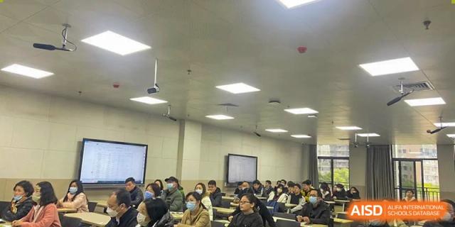 A large group of students from Wuhan Hongshan High School International Department seated in a classroom facing a white board.
