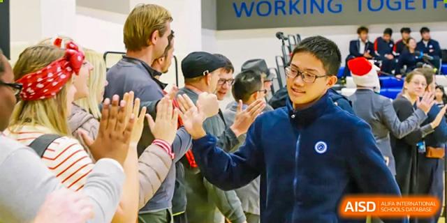 Students from BASIS International School Guangzhou celebrating or high-fiving during an activity or event.