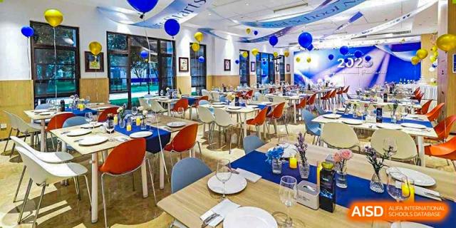 A bright and modern dining hall or restaurant area with tables set at BASIS International School Guangzhou.