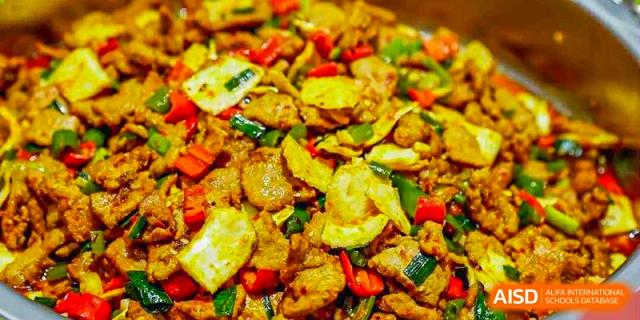 A stir-fry dish with sliced chicken or meat, peppers, and vegetables served at BASIS International School Guangzhou.