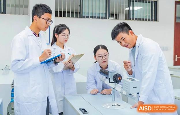 Chengdu No.7 High School International Department students collaborating on a science experiment in a laboratory setting.