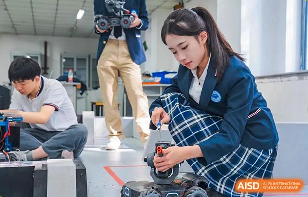 Chengdu No.7 High School International Department student working on a technical project with a tool, possibly for a robotics or engineering club.